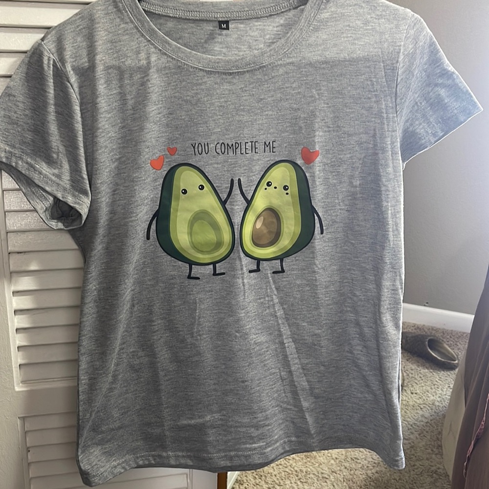 Grey tshirt. Size Medium. No brand name. 2 avocados saying "you complete me"